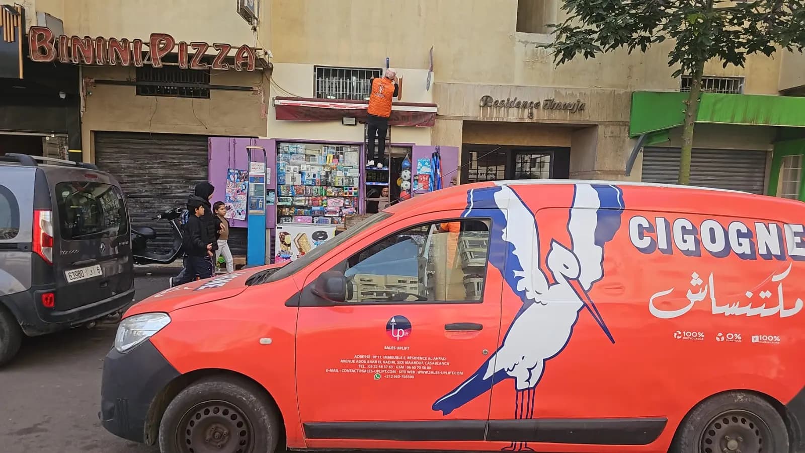 La Cigogne merchandising installation beside a branded field vehicle