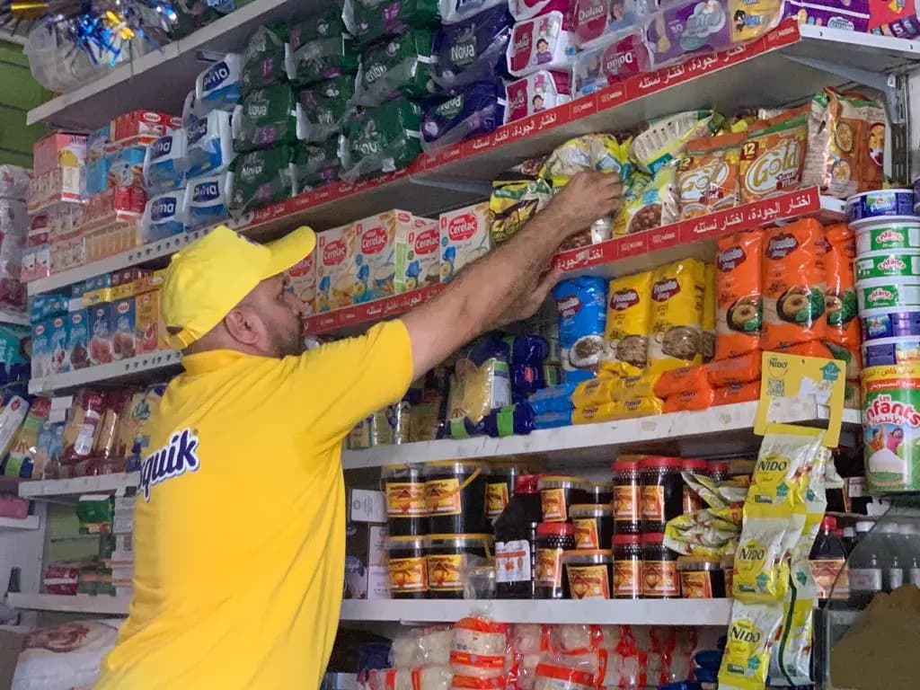 Nestlé salesperson merchandising products inside a grocery shop